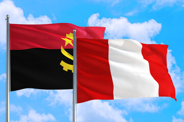 Fototapeta na wymiar Peru and Angola national flag waving in the windy deep blue sky. Diplomacy and international relations concept.