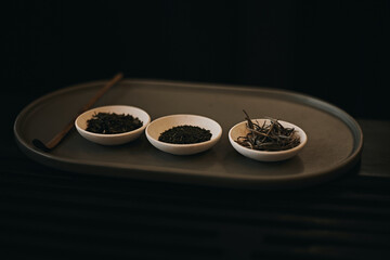 dried tea leaf in small bowl with dark background,