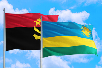 Rwanda and Angola national flag waving in the windy deep blue sky. Diplomacy and international relations concept.