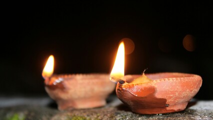 festival of light Diwali and two oil lamp is burning on the wall. Indian winter season festival.