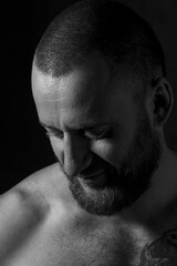 Studio session with one muscular man in low-key light conditions