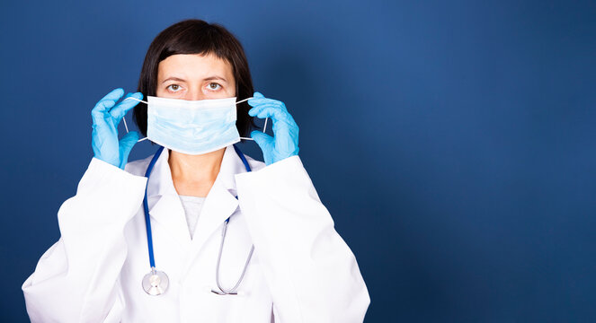 Woman Doctor Shows How To Put On A Protective Mask.