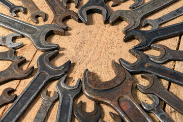 old vintage hand tools - set of wrenches on a wooden background with blank space for text