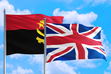 United Kingdom and Angola national flag waving in the windy deep blue sky. Diplomacy and international relations concept.