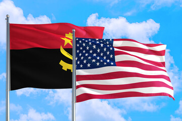 United States and Angola national flag waving in the windy deep blue sky. Diplomacy and international relations concept.