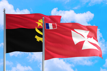 Wallis And Futuna and Angola national flag waving in the windy deep blue sky. Diplomacy and international relations concept.