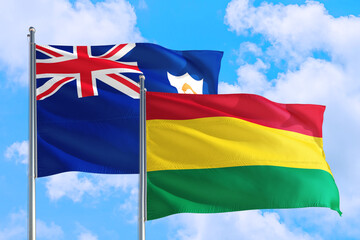 Bolivia and Anguilla national flag waving in the windy deep blue sky. Diplomacy and international relations concept.