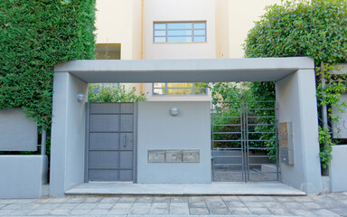 modern design residential apartment building  front entrance metallic door