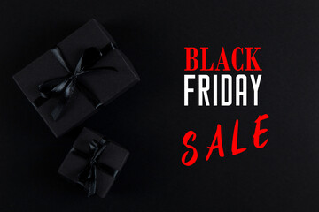 Black gift paper black background. Dark concept, sales. Black friday advertisement banner, promotion inscription.