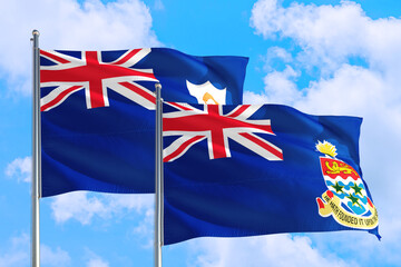 Cayman Islands and Anguilla national flag waving in the windy deep blue sky. Diplomacy and international relations concept.