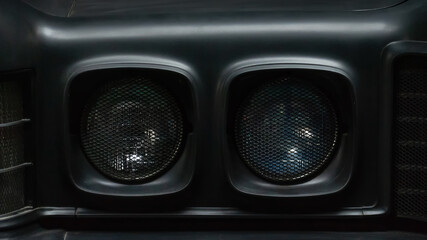 Headlights of a black old retro car. Close-up. Details.