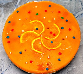 Cheesecake with orange jelly and orange slices close up