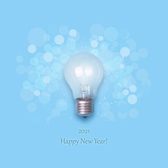 2021 Happy New Year. Light bulb on a blue background.