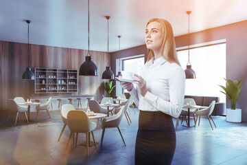 Woman with coffee in wooden cafe interior