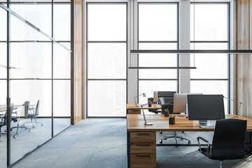 Wooden office tables with computers view on the city, office room with big windows