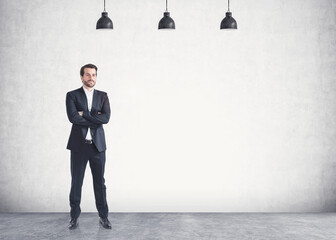 Fototapeta premium Confident young businessman with crossed arms, mock up