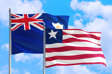 Liberia and Anguilla national flag waving in the windy deep blue sky. Diplomacy and international...
