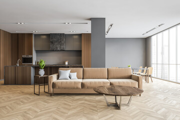 Wooden kitchen with brown sofa in living room, new furniture in studio apartment