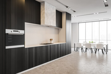Black kitchen set on grey floor with table and chairs near window in flat