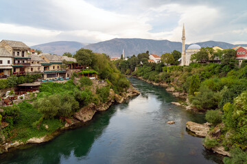 Fototapeta na wymiar Old town of Mostar, Bosnia and Herzegovina, view from Stari Most bridget to Neretva river and old mosques