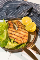 Homemade organic salmon steak with lettuce leaves