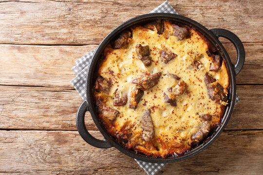 Tave kosi is a national Albanian dish of baked lamb and rice with yoghurt close-up in a pan on the table. horizontal top view from above
