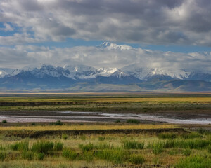 View of Lenin Peak nowadays Ibn Sina peak in the snow-capped Trans-Alay or Trans-Alai mountain range in southern Kyrgyzstan with Kyzyl Suu river in the midground