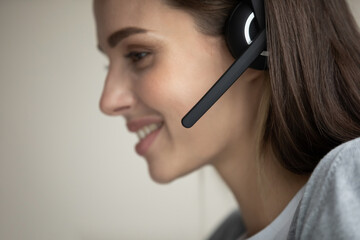 I am your personal advisor. Profile shot of smiling young female in portable wireless headphone set...