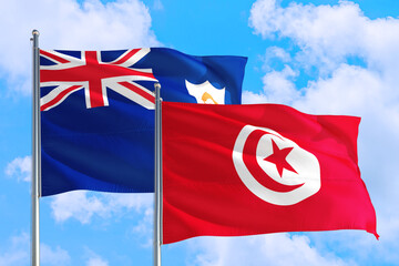 Tunisia and Anguilla national flag waving in the windy deep blue sky. Diplomacy and international...