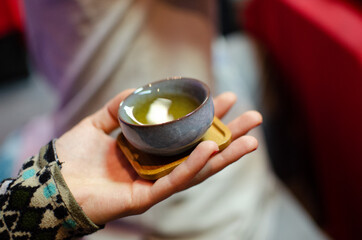 Cup with tea in hand