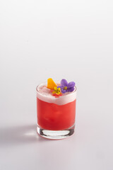Summer refreshing cocktail with ice and alcohol. Whiskey, cherry syrup, strawberry syrup, mandarin syrup, egg white.