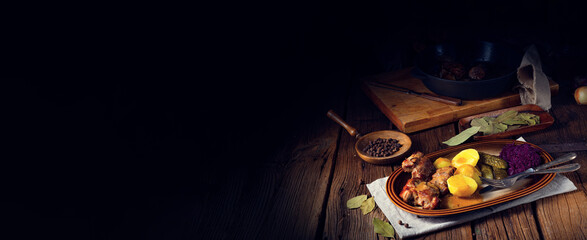 Rustic Snirtjebraten with red cabbage and cucumber