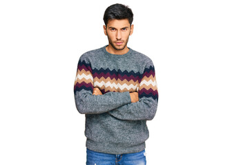 Young handsome man wearing casual winter sweater skeptic and nervous, disapproving expression on...
