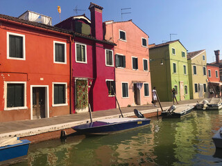 Fototapeta na wymiar Burano island canal and colorful houses with boats in Venice Italy