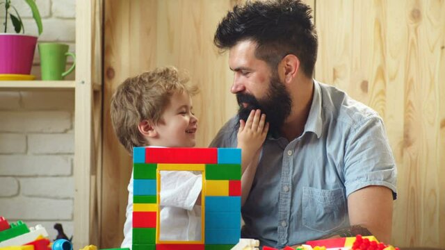 Smiling father and preschooler son hug cuddle together, happy dad and cute little boy child show support and care.