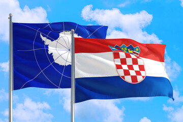 Croatia and Antarctica national flag waving in the windy deep blue sky. Diplomacy and international relations concept.