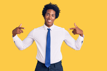 Handsome african american man with afro hair wearing business clothes looking confident with smile...