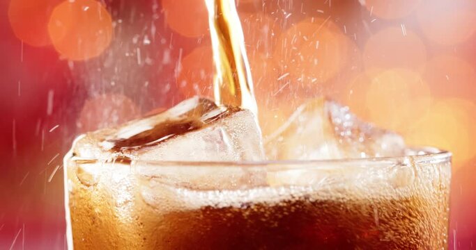 Glass of cola. Ice cola with splashing bubbles slow motion on a blurry light ,blurry background.