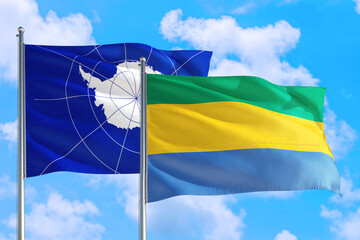 Gabon and Antarctica national flag waving in the windy deep blue sky. Diplomacy and international relations concept.