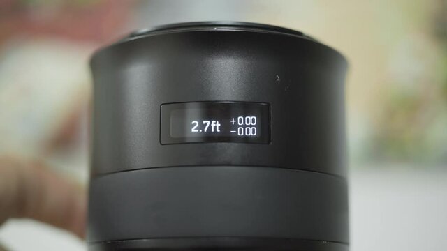 Close-up of modern electronic lens. Action. New generation of professional lenses for cameras with electronic ring values. Ring values are displayed on lens screen