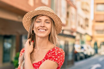 Young blonde tourist woman wearing summer style walking at the city.