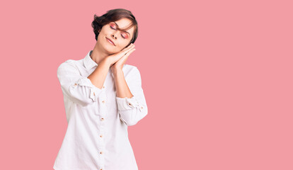 Beautiful young woman with short hair wearing elegant white shirt sleeping tired dreaming and posing with hands together while smiling with closed eyes.