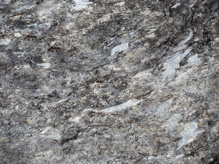 Closeup of rock surface, black and white stain pattern