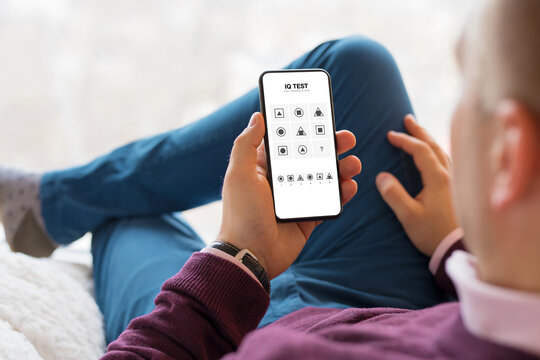Man submitting IQ test on mobile phone