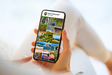 Person looking at nature and landscape photographs on mobile phone