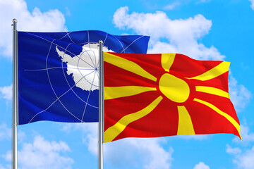 Macedonia and Antarctica national flag waving in the windy deep blue sky. Diplomacy and international relations concept.