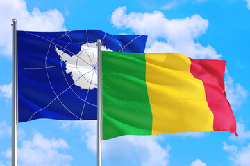 Mali and Antarctica national flag waving in the windy deep blue sky. Diplomacy and international relations concept.