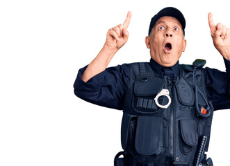 Senior handsome man wearing police uniform amazed and surprised looking up and pointing with...
