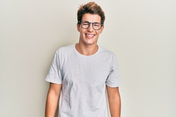 Handsome caucasian man wearing casual clothes and glasses with a happy and cool smile on face. lucky person.