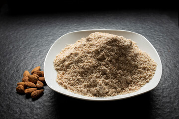 grounded almonds in white plate